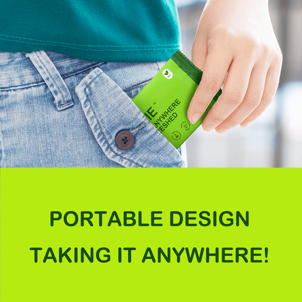 Hand placing a TINKKIE portable body wipes travel pack into a denim pocket